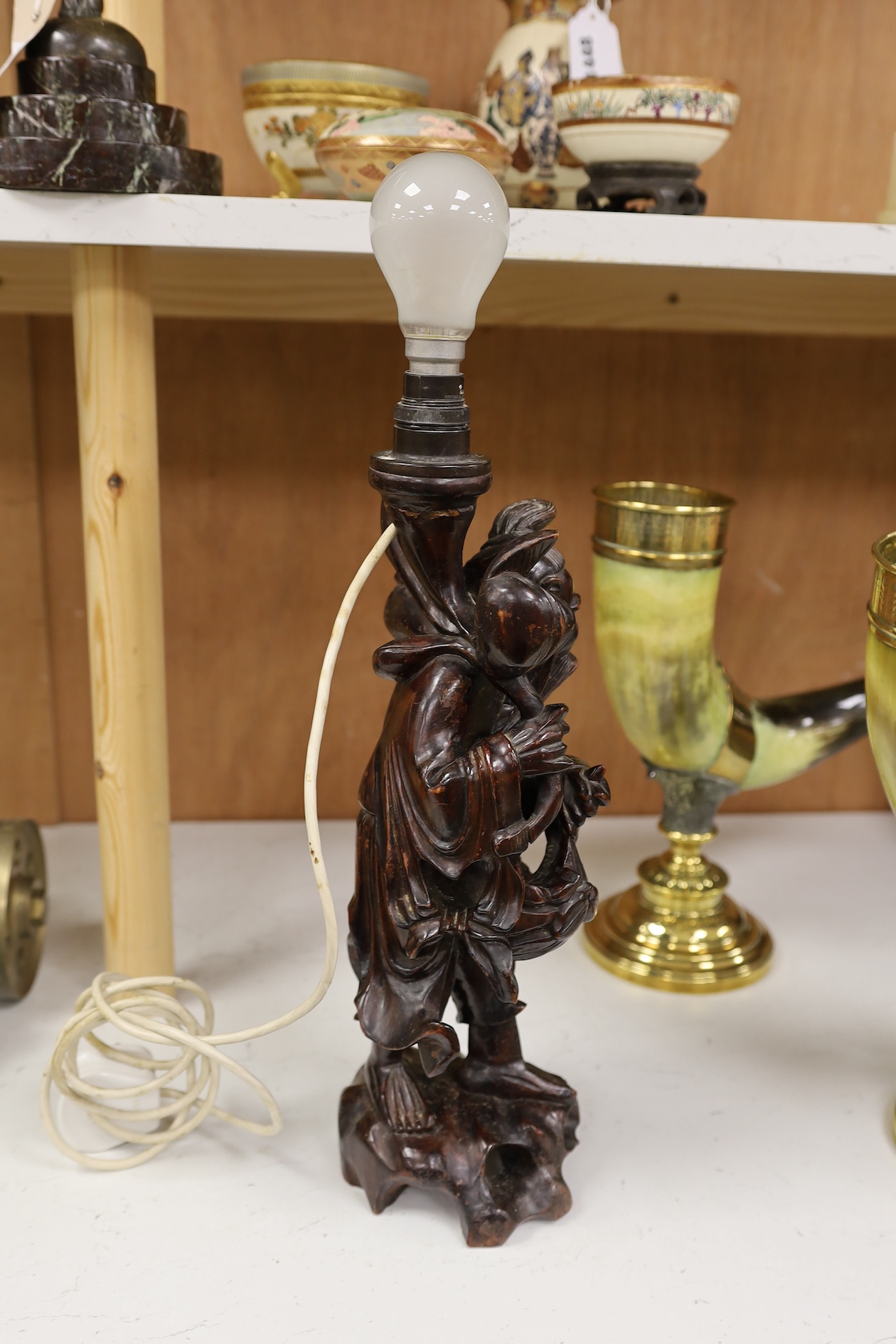 A Chinese carved wooden figural table lamp base, 36cm high not including light fitting. Condition - rubbed in places